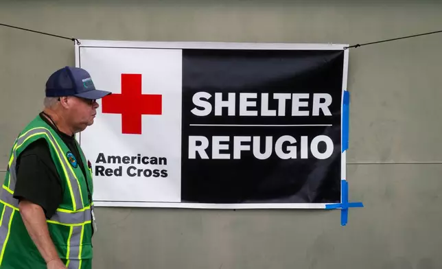 An American Red Cross volunteer walks outside Freedom Hall, an evacuation center in Fountain Valley, Calif.,on Monday, May 25, 2026. (AP Photo/Ethan Swope)