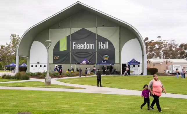 People walk outside Freedom Hall, an evacuation center in Fountain Valley, Calif., on Monday, May 25, 2026. (AP Photo/Ethan Swope)