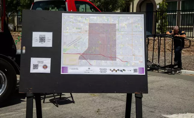 An evacuation map is displayed at the incident command post at the Los Alamitos Race Course in Cypress, Calif., on Sunday, May 24, 2026. (AP Photo/Ethan Swope)