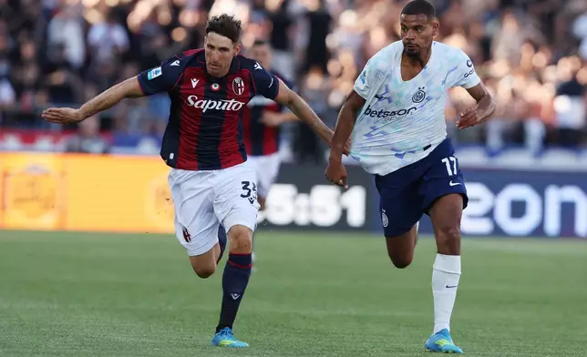 Bologna's Juan Miranda fights for the ball with Inter's Andy Diouf, right, during the Serie A soccer match between Bologna and Inter Milan, in Bologna, Italy, Saturday, May 23, 2026. (Gianni Santandrea/LaPresse via AP)