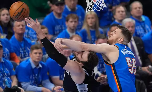 Oklahoma City Thunder center Isaiah Hartenstein (55) blocks a shot by San Antonio Spurs center Luke Kornet (7) during the first half of Game 1 in a third-round NBA basketball playoffs series Monday, May 18, 2026, in Oklahoma City. (AP Photo/Tony Gutierrez)