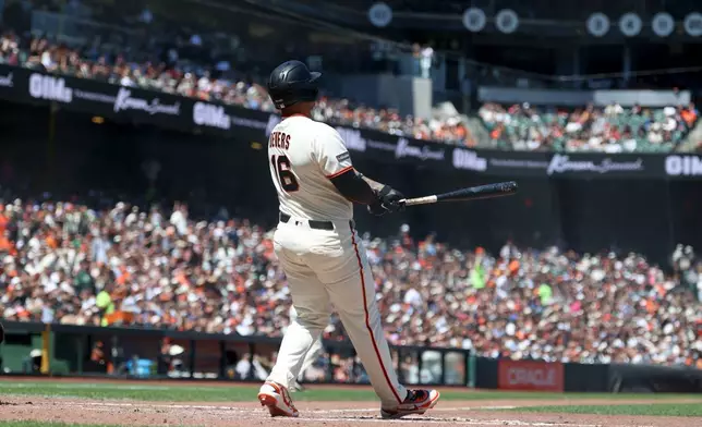 San Francisco Giants' Rafael Devers watches his grand slam during the fifth inning of a baseball game against the Chicago White Sox in San Francisco, Sunday, May 24, 2026. (AP Photo/Jed Jacobsohn)