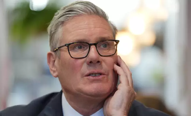 Britain's Prime Minister Keir Starmer speaks to small business owners during a visit to Home Cafe and Kitchen in London, Monday, May 18, 2026, as new figures have shown the UK recorded stronger than expected economic growth. (Yui Mok/Pool Photo via AP)