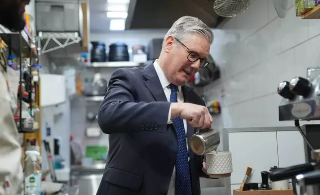 Britain's Prime Minister Keir Starmer pours milk into a cup of tea he made a visit to Home Cafe and Kitchen in London, Monday, May 18, 2026, as new figures have shown the UK recorded stronger than expected economic growth. (Yui Mok/Pool Photo via AP)