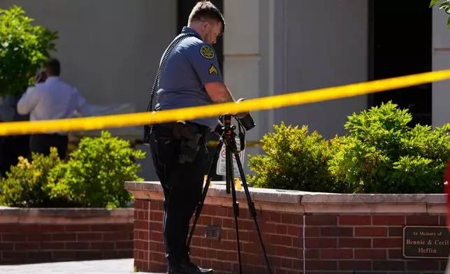 A Sheriff's deputy investigates a shooting scene outside the Montgomery County Courthouse, Wednesday, May 13, 2026, in Clarksville, Tenn. (AP Photo/George Walker IV)