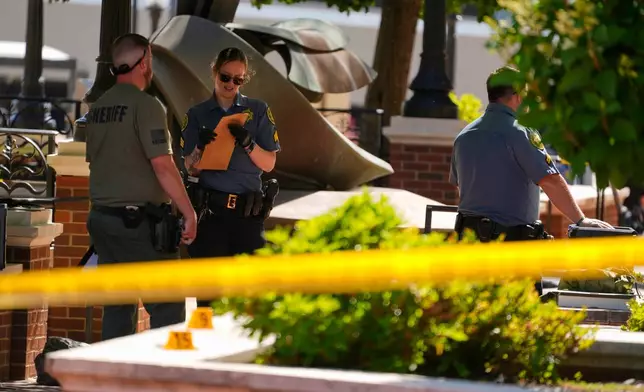 Sheriff's deputies investigate a shooting scene outside the Montgomery County Courthouse, Wednesday, May 13, 2026, in Clarksville, Tenn. (AP Photo/George Walker IV)