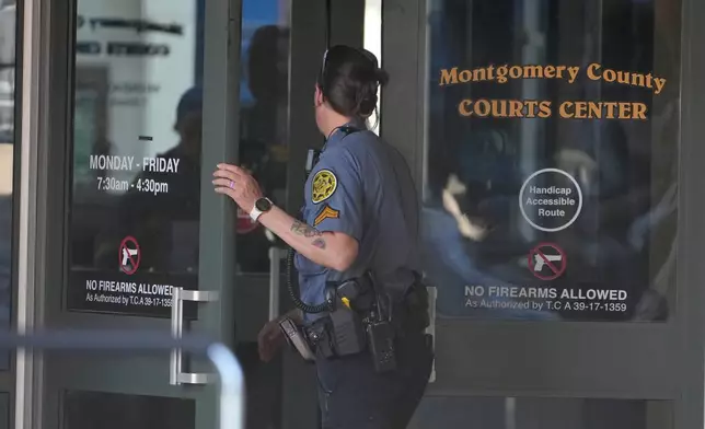 A Sheriff's deputy enters the Montgomery County Courts Center as they investigate a shooting outside the building, Wednesday, May 13, 2026, in Clarksville, Tenn. (AP Photo/George Walker IV)