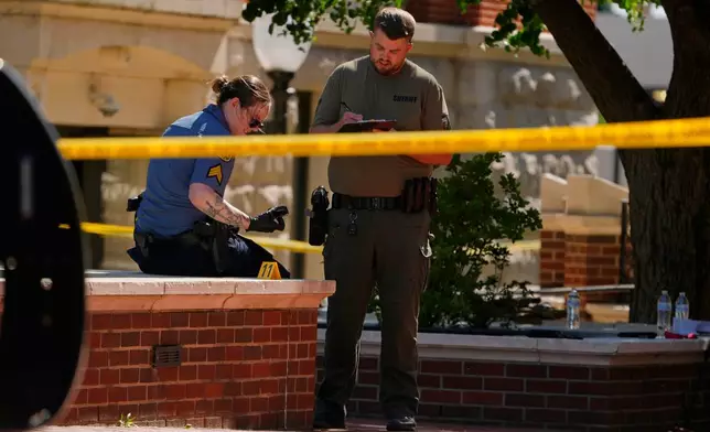 Sheriff's deputies investigate a shooting scene outside the Montgomery County Courthouse, Wednesday, May 13, 2026, in Clarksville, Tenn. (AP Photo/George Walker IV)
