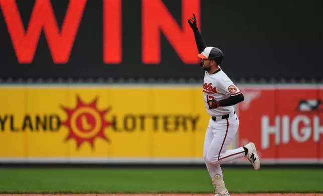 Baltimore Orioles' Colton Cowser rounds the bases after hitting a walkoff three-run home run during the ninth inning in the first baseball game of a doubleheader against the Detroit Tigers, Sunday, May 24, 2026, in Baltimore. (AP Photo/Stephanie Scarbrough)