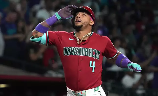 Arizona Diamondbacks' Ketel Marte reacts after hitting a solo home run against the Colorado Rockies in the fourth inning of a baseball game, Saturday, May 23, 2026, in Phoenix. (AP Photo/Rick Scuteri)