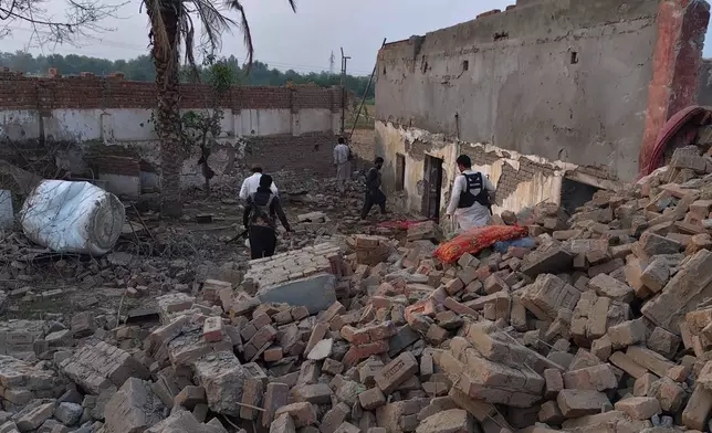 Police officers examine the site of overnight suicide bombing at a security post in Fatah Khel, in Bannu, a district in Pakistan's Khyber Pakhtunkhwa province bordering Afghanistan, Sunday, May 10, 2026. (AP Photo/Aamad Khattak)