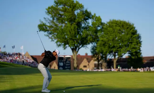 Aaron Rai, of England, hits his approach shot from the 18th fairway during the final round of the PGA Championship golf tournament at Aronimink Golf Club, Sunday, May 17, 2026, in Newtown Square, PA. (AP Photo/Carolyn Kaster)