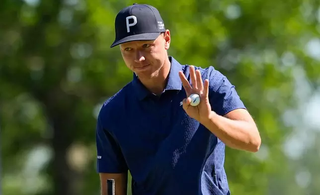 Matti Schmid, of Germany, waves on the 18th green during the third round of the PGA Championship golf tournament at Aronimink Golf Club, Saturday, May 16, 2026, in Newtown Square, PA. (AP Photo/Frank Franklin II)
