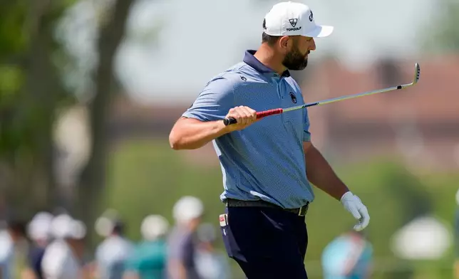Jon Rahm, of Spain, looks at his club on the third fairway during the final round of the PGA Championship golf tournament at Aronimink Golf Club, Sunday, May 17, 2026, in Newtown Square, PA. (AP Photo/Matt Slocum)