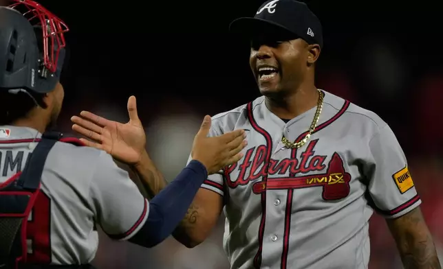Atlanta Braves pitcher Raisel Iglesias, right, celebrates with catcher Chadwick Tromp after winning a baseball game against the Cincinnati Reds in Cincinnati, Saturday, May 30, 2026. (AP Photo/Carolyn Kaster)