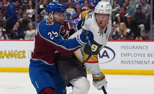 Colorado Avalanche center Nathan MacKinnon, left, checks Vegas Golden Knights center Jack Eichel during the second period in Game 2 of the Western Conference finals NHL hockey Stanley Cup playoff series Friday, May 22, 2026, in Denver. (AP Photo/David Zalubowski)