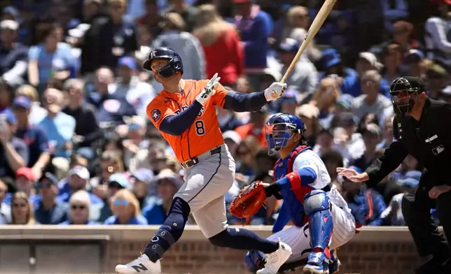 Houston Astros' Christian Walker (8) watches his two-run home run during the first inning of a baseball game against the Chicago Cubs in Chicago, Saturday, May 23, 2026. (AP Photo/Paul Beaty)