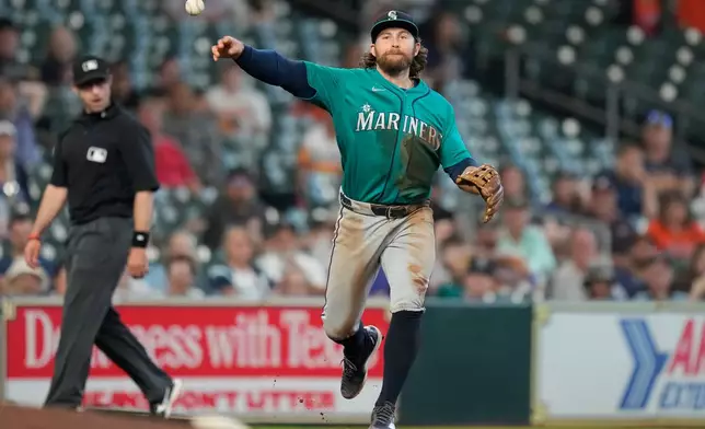 Seattle Mariners third baseman Brendan Donovan throws to first to out Houston Astros' Jose Altuve during the seventh inning of a baseball game in Houston, Thursday, May 14, 2026. (AP Photo/Ashley Landis)