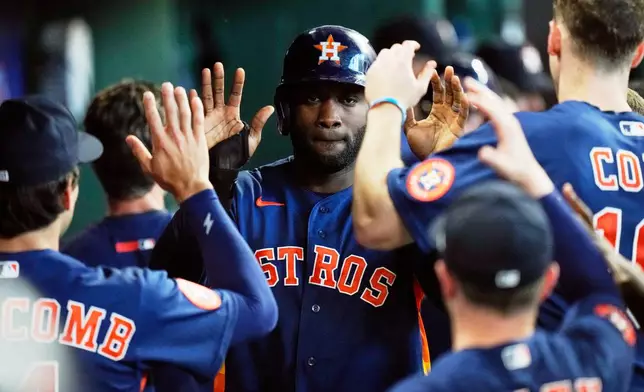 Houston Astros designated hitter Yordan Alvarez celebrates in the dugout after scoring during the sixth inning of a baseball game against the Seattle Mariners in Houston, Thursday, May 14, 2026. (AP Photo/Ashley Landis)