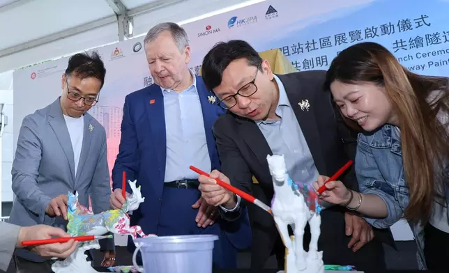 Guests joined hands to paint mini horse sculptures at the launch ceremony.