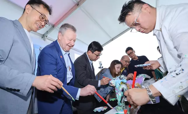 Guests joined hands to paint mini horse sculptures at the launch ceremony.