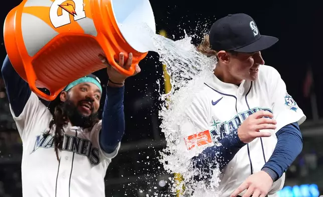Seattle Mariners' Colt Emerson, right, is doused by teammate J.P. Crawford, left, to celebrate a win over the Chicago White Sox in a baseball game, Monday, May 18, 2026, in Seattle. (AP Photo/Lindsey Wasson)