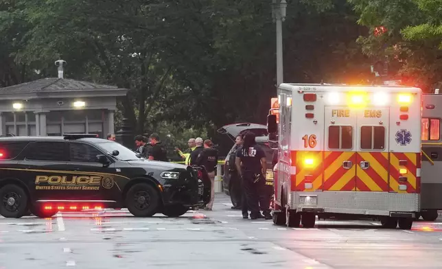 Police and members of the Secret Service stand near an EMS truck after blocking streets around the White House, Saturday, May 23, 2026, in Washington. (AP Photo/Alex Brandon)