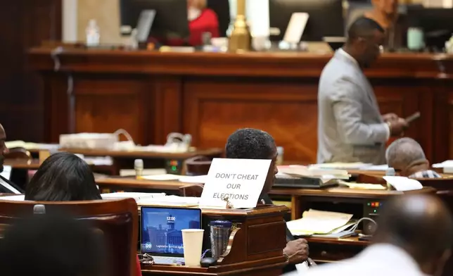 A sign sits on the desk of Democratic South Carolina Rep. Annie McDaniel during the House redistricting debate on Tuesday, May 19, 2026, in Columbia, S.C. (AP Photo/Jeffrey Collins)