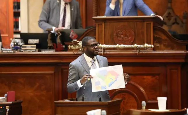 Democratic South Carolina Rep. Kambrell Garvin presents his version of a map for new congressional districts during the House session on redistricting on Monday, May 18, 2026, in Columbia, S.C. (AP Photo/Jeffrey Collins)