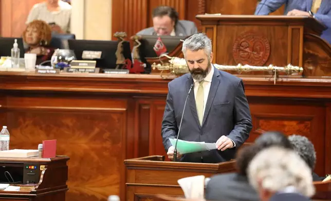 Republican South Carolina Rep. Micah Caskey reads a resolution limiting debate during the House session on redistricting on Monday, May 18, 2026, in Columbia, S.C. (AP Photo/Jeffrey Collins)