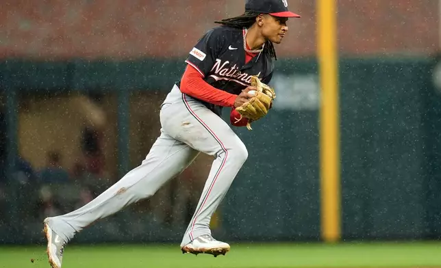 Washington Nationals shortstop CJ Abrams fields a ball hit by Atlanta Braves' Matt Olson (28) in the sixth inning of a baseball game, Sunday, May 24, 2026, in Atlanta. (AP Photo/Mike Stewart)