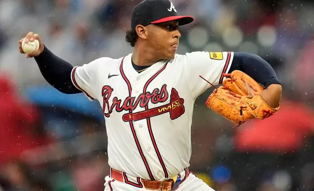 Atlanta Braves pitcher Didier Fuentes works in the rain in the sixth inning of a baseball game against the Washington Nationals, Sunday, May 24, 2026, in Atlanta. (AP Photo/Mike Stewart)