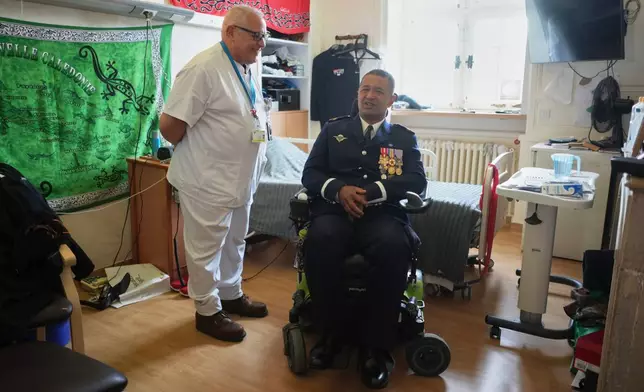 Master corporal Mikaele Iva and nurse coordinator, Mustapha Nachet, talk at the National Institution of Invalides in Paris, on May 6, 2026.(AP Photo/Thibault Camus)