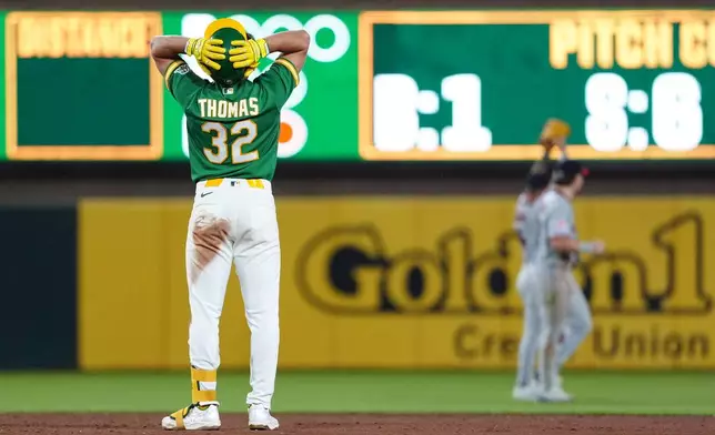 Athletics' Colby Thomas (32) reacts after hitting a long fly ball to the wall for an out in the eighth inning of a a baseball game against the Cleveland Guardians Friday, May 1, 2026, in West Sacramento, Calif. (AP Photo/Alan Greth)