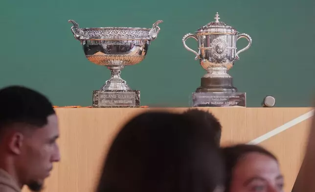The men's, left, and women's trophies are displayed during the draw for the French Open tennis tournament, Thursday, May 21, 2026, at the Roland Garros stadium in Paris. (AP Photo/Thibault Camus)