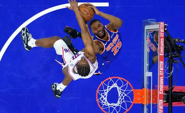 New York Knicks' Mikal Bridges, right, goes up for a shot against Philadelphia 76ers' Tyrese Maxey during the second half of Game 3 in a second-round NBA basketball playoff series Friday, May 8, 2026, in Philadelphia. (AP Photo/Matt Slocum)