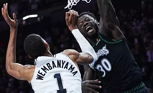 Minnesota Timberwolves forward Julius Randle (30) scores over San Antonio Spurs forward Victor Wembanyama (1) during the first half of Game 6 of an NBA basketball second-round playoffs series in Minneapolis, Friday, May 15, 2026. (AP Photo/Abbie Parr)