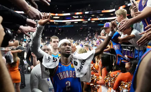 Oklahoma City Thunder guard Shai Gilgeous-Alexander celebrates with fans after Game 4 in a first-round NBA playoffs basketball series against the Phoenix Suns, Monday, April 27, 2026, in Phoenix. (AP Photo/Ross D. Franklin)