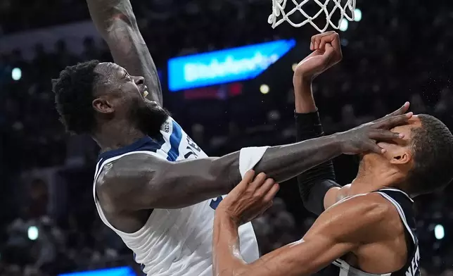Minnesota Timberwolves forward Julius Randle (30) drives to the basket against San Antonio Spurs forward Victor Wembanyama (1) during the second half of Game 5 of an NBA basketball second-round playoffs series in Minneapolis, Tuesday, May 12, 2026. (AP Photo/Eric Gay)
