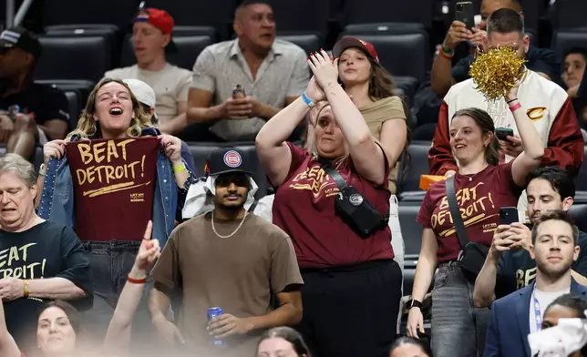 Cleveland Cavaliers fans celebrate a win over the Detroit Pistons during the fourth quarter of in Game 7 in a second-round NBA basketball playoffs series Sunday, May 17, 2026, in Detroit. (AP Photo/Duane Burleson)