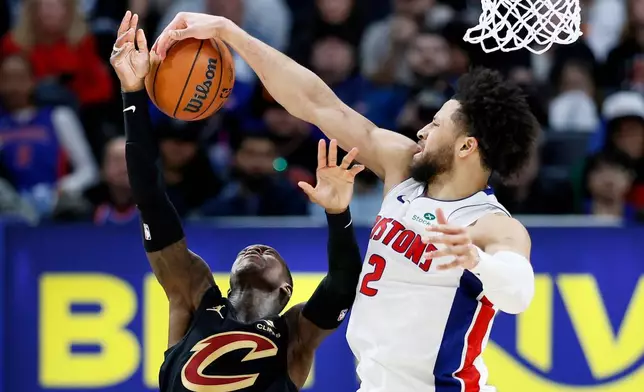Detroit Pistons guard Cade Cunningham (2) blocks a shot attempted by Cleveland Cavaliers guard Dennis Schroder (8) during the second half in Game 2 of a second-round NBA playoffs basketball series, Thursday, May 7, 2026, in Detroit. (AP Photo/Duane Burleson)