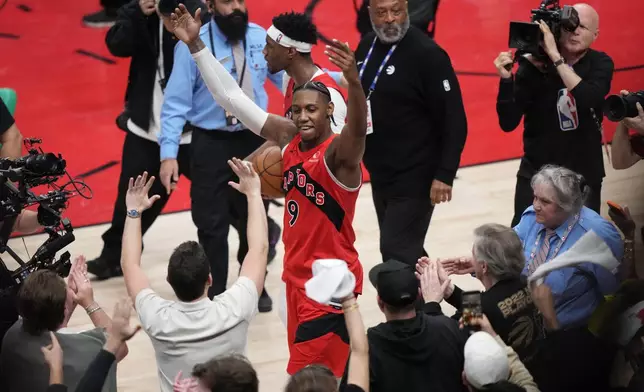 Toronto Raptors' RJ Barrett (9) celebrates with fans after a win over the Cleveland Cavaliers in Game 6 in the first round of an NBA basketball playoffs series in Toronto, Friday, May 1, 2026. (Nathan Denette/The Canadian Press via AP)