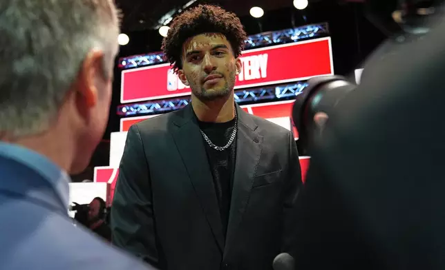 Duke forward Cameron Boozer talks to media during the NBA basketball draft lottery in Chicago, Sunday, May 10, 2026. (AP Photo/Nam Y. Huh)