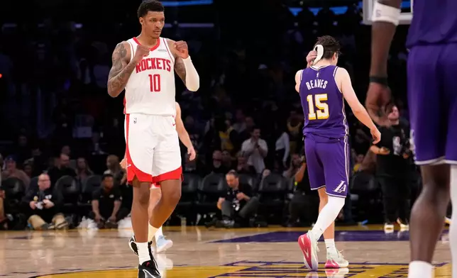 Houston Rockets forward Jabari Smith Jr., left, celebrates as Los Angeles Lakers guard Austin Reaves walks off after the Rockets defeated the Lakers in Game 5 of a first-round NBA playoffs basketball series Wednesday, April 29, 2026, in Los Angeles. (AP Photo/Mark J. Terrill)