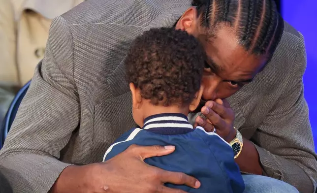 Oklahoma City Thunder guard Shai Gilgeous-Alexander whispers to his son Ares Alexander before a news conference after Gilgeous-Alexander was named the NBA basketball MVP, Sunday, May 17, 2026, in Oklahoma City. (AP Photo/Nate Billings)