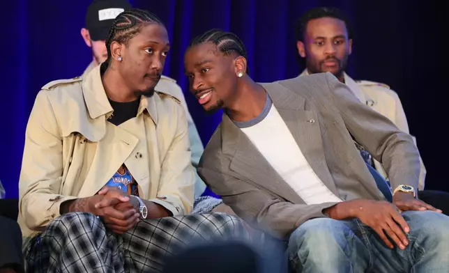 Oklahoma City Thunder guard Shai Gilgeous-Alexander, right, talks to guard Jalen Williams, left, before a news conference after Gilgeous-Alexander was named the NBA basketball MVP as guard Cason Wallace, back right, looks on, Sunday, May 17, 2026, in Oklahoma City. (AP Photo/Nate Billings)