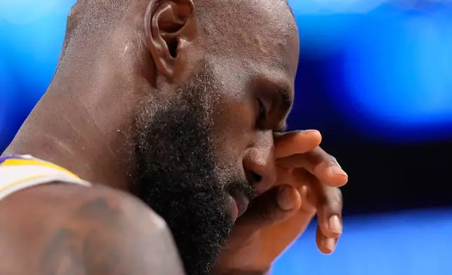 Los Angeles Lakers forward LeBron James wipes his eye in the closing minutes in the second half of Game 3 in a second-round NBA basketball playoffs series against the Oklahoma City Thunder, Saturday, May 9, 2026, in Los Angeles. (AP Photo/Mark J. Terrill)