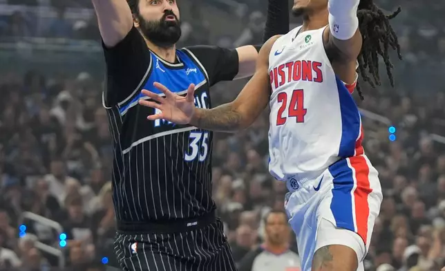 Detroit Pistons guard Daniss Jenkins (24) goes up to shoot over Orlando Magic center Goga Bitadze (35) during the first half in Game 6 of a first-round NBA basketball playoffs series, Friday, May 1, 2026, in Orlando, Fla. (AP Photo/John Raoux)