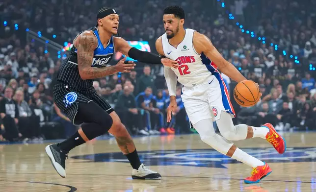 Detroit Pistons forward Tobias Harris (12) drives against Orlando Magic forward Paolo Banchero (5) during the first half in Game 6 of a first-round NBA basketball playoffs series, Friday, May 1, 2026, in Orlando, Fla. (AP Photo/John Raoux)