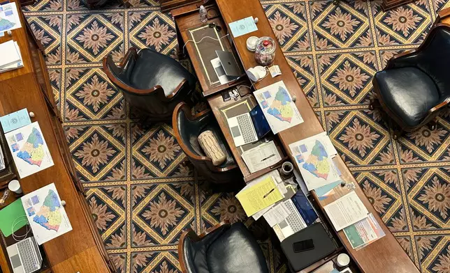 A new suggested map for South Carolina congressional districts sits on senators' desks, Thursday, May 21, 2026, in Columbia, S.C. (AP Photo/Jeffrey Collins)